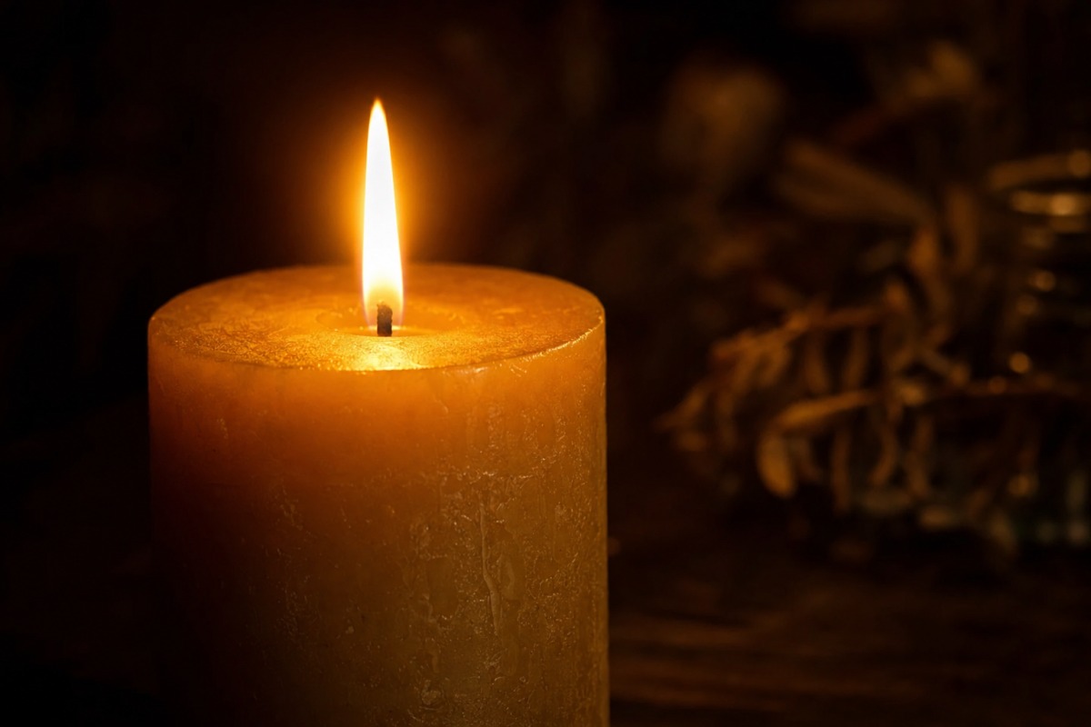 Close-up of the even flame of a burning handmade candle
